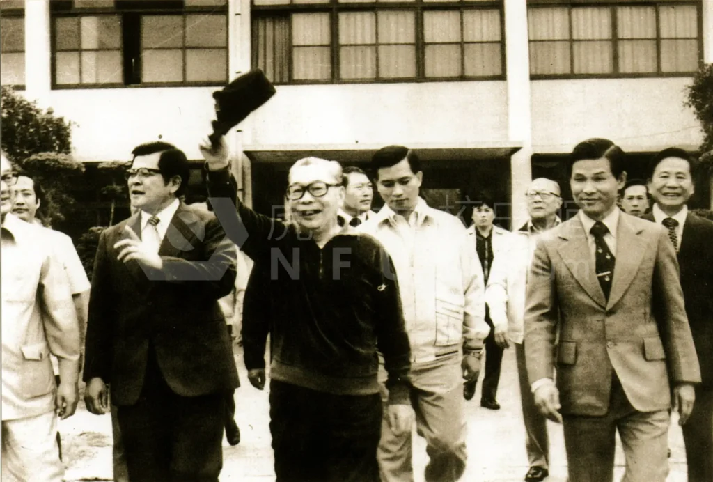 A group of people are walking，one person tips their hat to others。